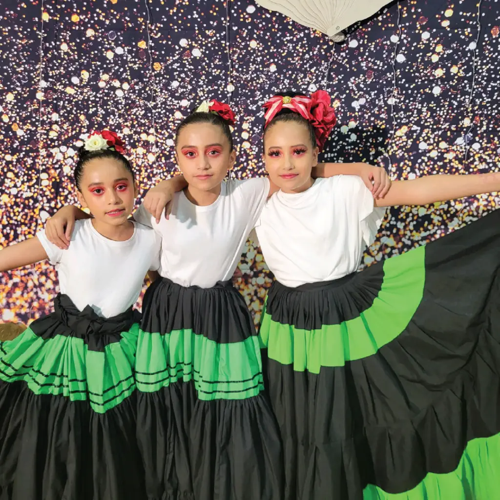 Youth impact daily activities folklore dance girls in black and green traditional dresses.