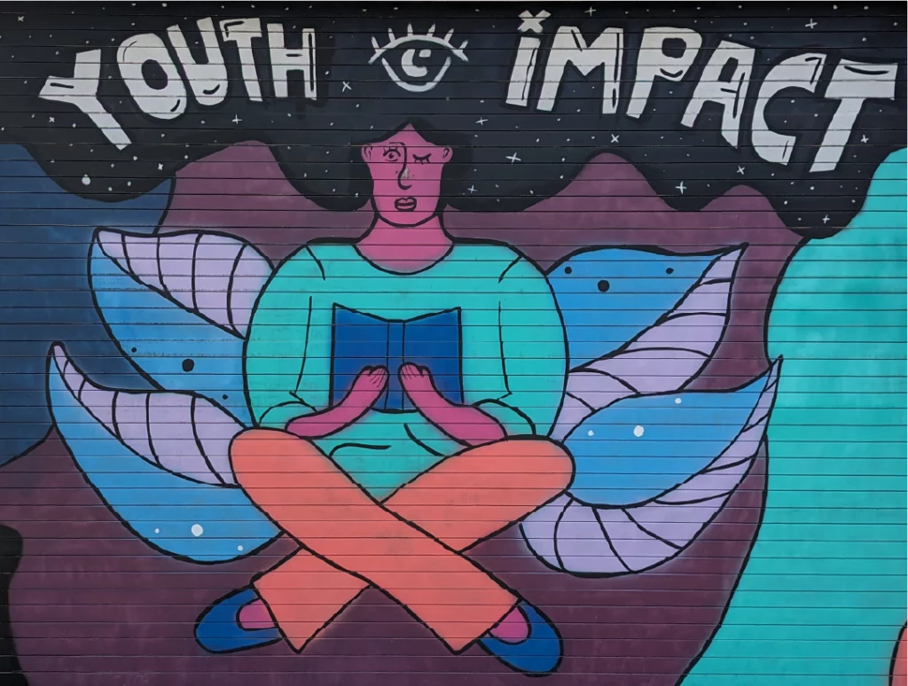 Youth impact person reading mural.